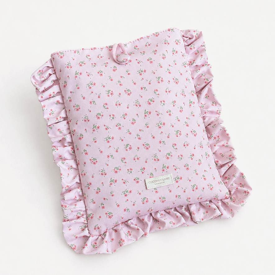 Pink floral patterned Book Sleeve with ruffled trim.