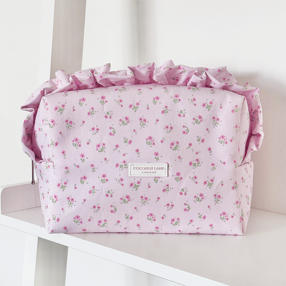 Pink floral Makeup Bag with ruffle trim and Coconut Lane logo.