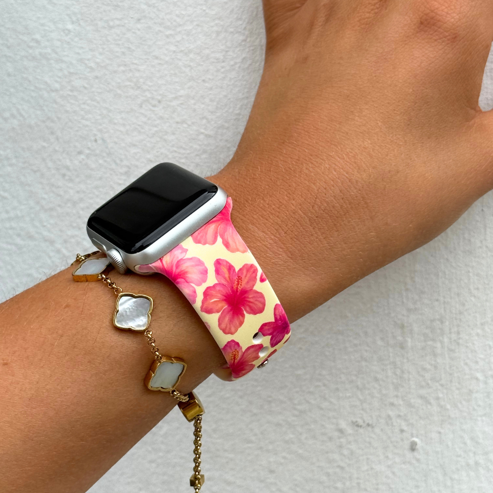 Butter yellow hibiscus Apple Watch strap with a gold bracelet featuring square white stones.