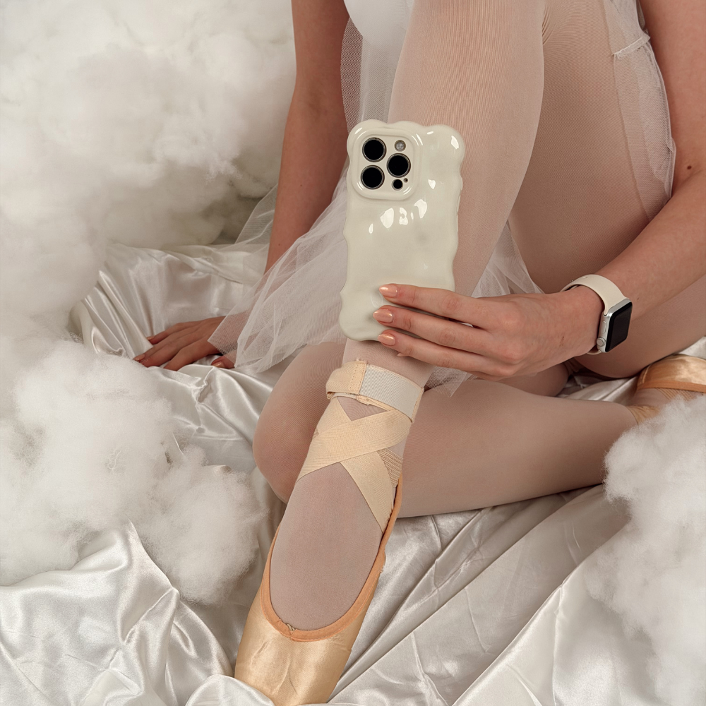 Girl sat in clouds holding the Cloud Dancer Phone Case