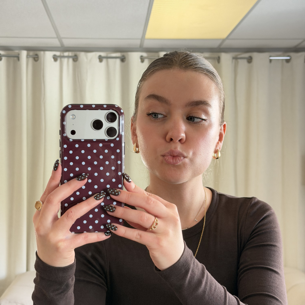 Girl with matching brown polka dot nails to the brown and blue polka dot tough phone case