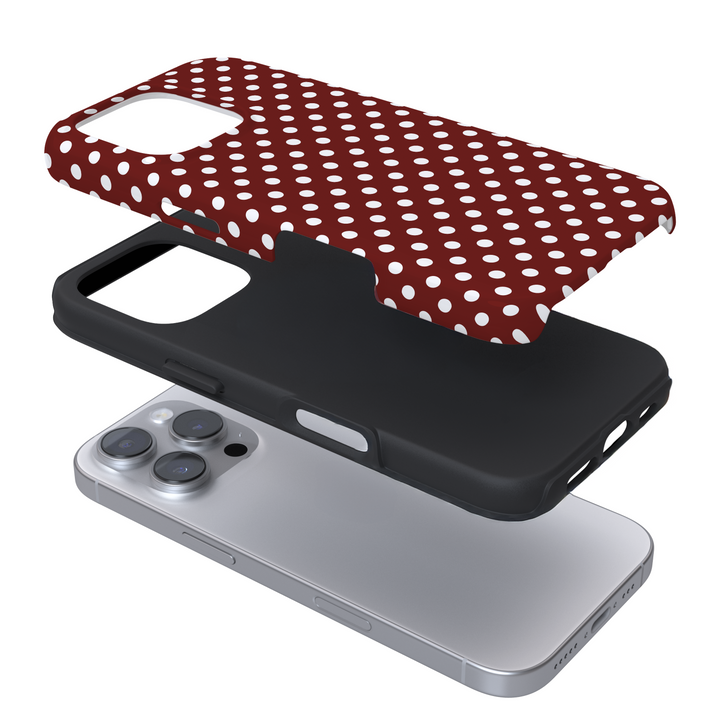 Expanded view of a phone case with a burgundy and white polka dot pattern on a white background