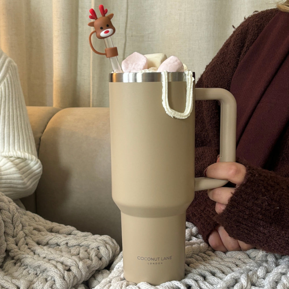 Coconut Lane stainless steel tumbler in Caramel Latte color with marshmallows, reindeer straw, and a knitted sweater wrap.