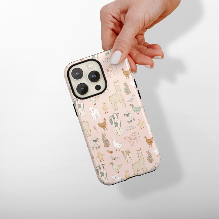 Phone case with animal pattern held by a hand on a light background