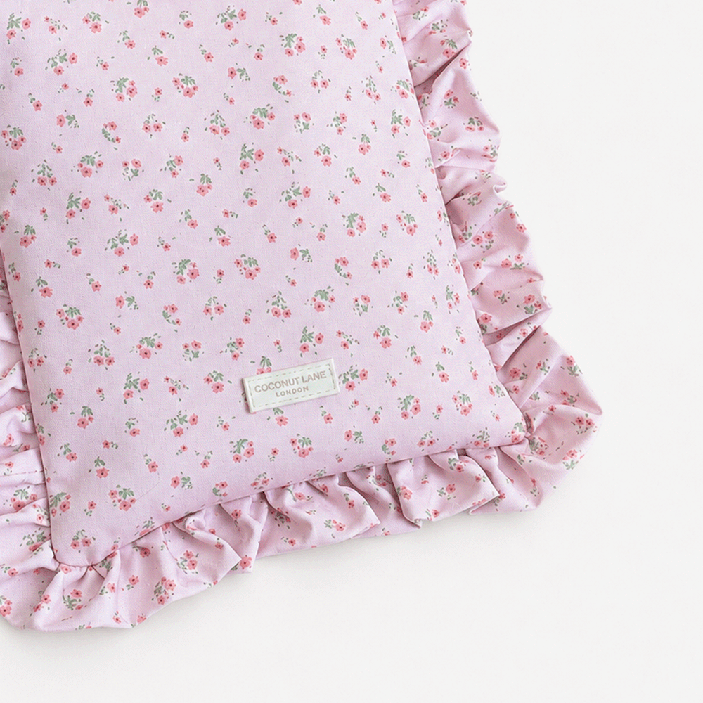 Pink floral patterned Book Sleeve with ruffled trim.