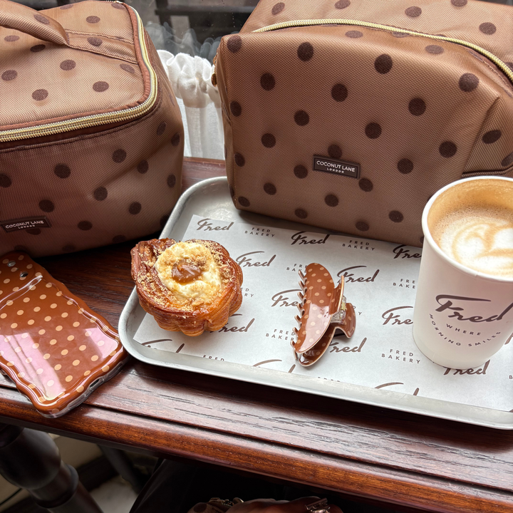 Dot Society chocolate brown makeup bag. Sheer mesh brown material with brown polka dot detailing. Alongside the matching claw clip, wavy phone case and vanity case.
