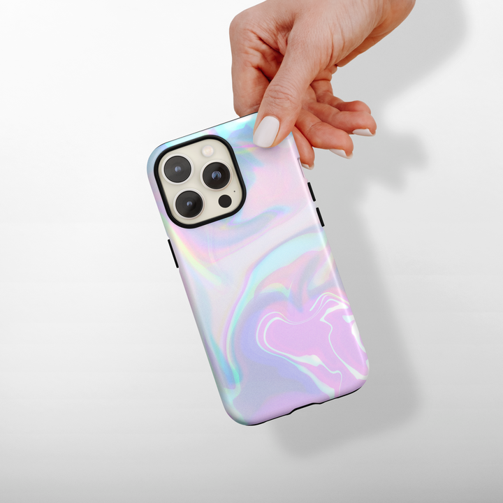 Phone case with a colorful, iridescent design held by a hand on a light gray background