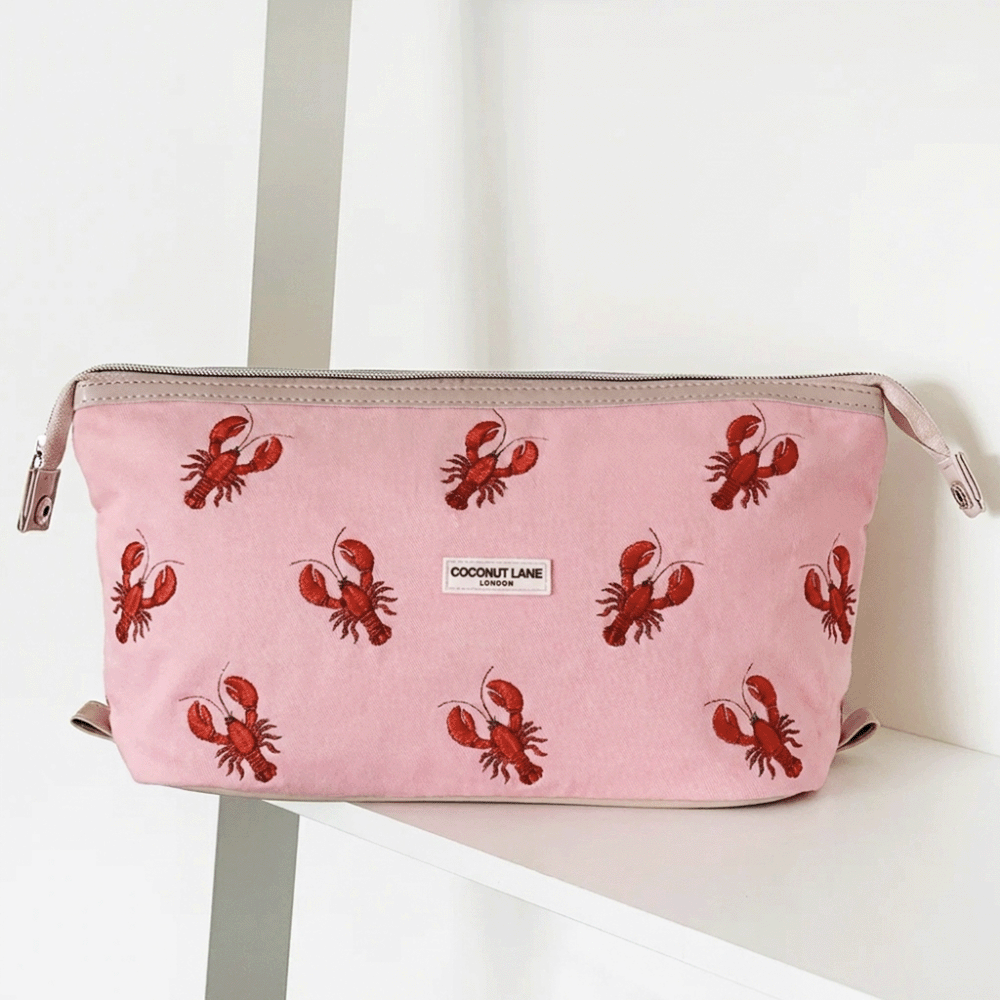 Pink velvet material Makeup Bag with zip closure and Coconut Lane logo. Embroidered with red lobsters.