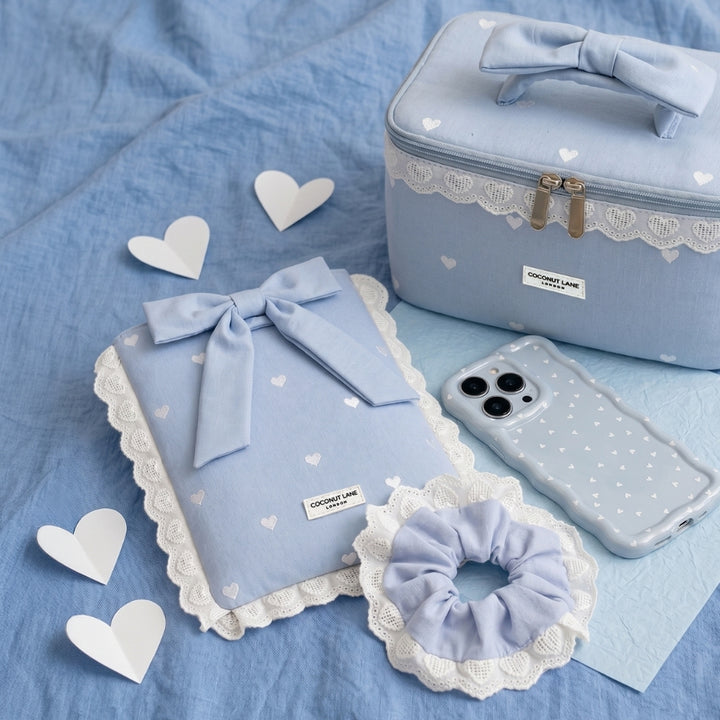 Powder blue hearts collection on blue linen backdrop surrounded by white cut out hears.