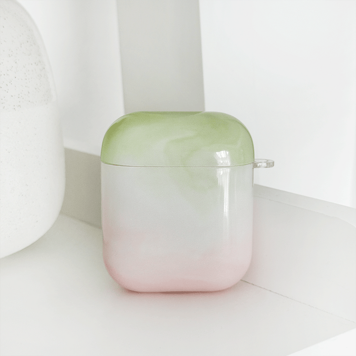 Green and pink ombre effect AirPods Case. Colour fades from green at the top into white, into pink. 