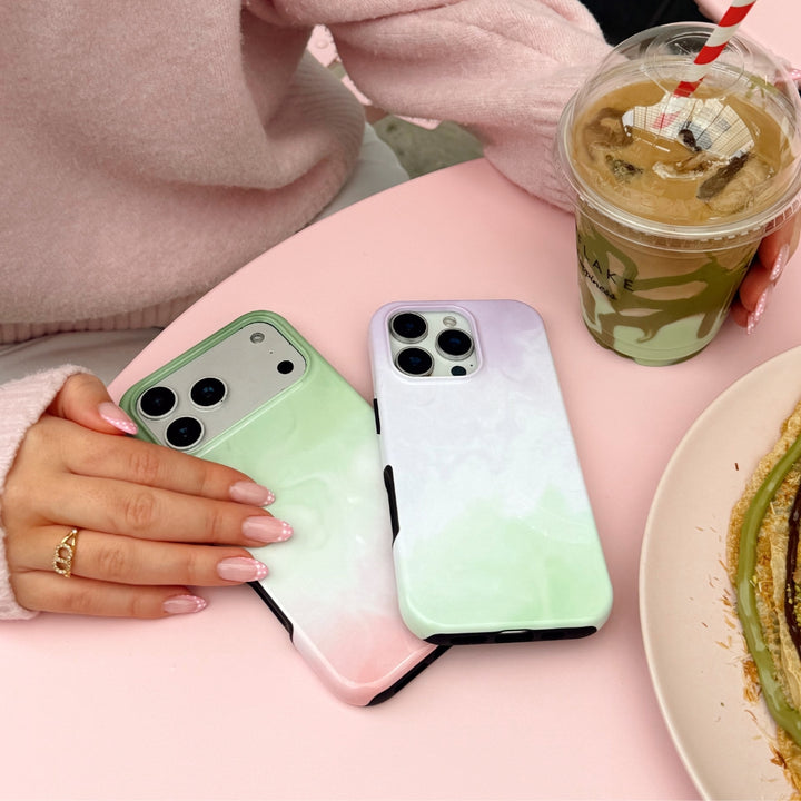Strawberry Matcha and Lavender Matcha phone cases next to eachother on pink surface.