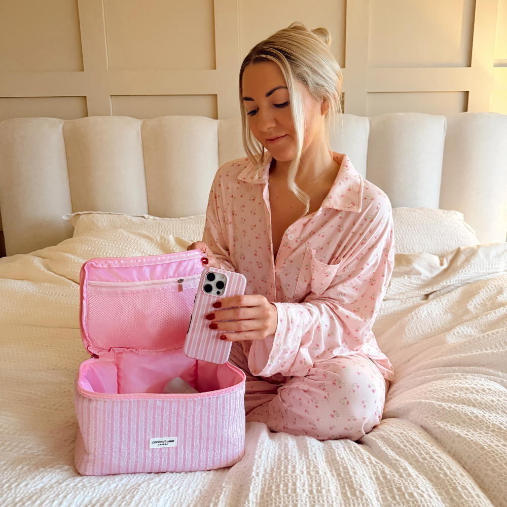 Girl placing phone case into the Powder Stripes Vanity Case