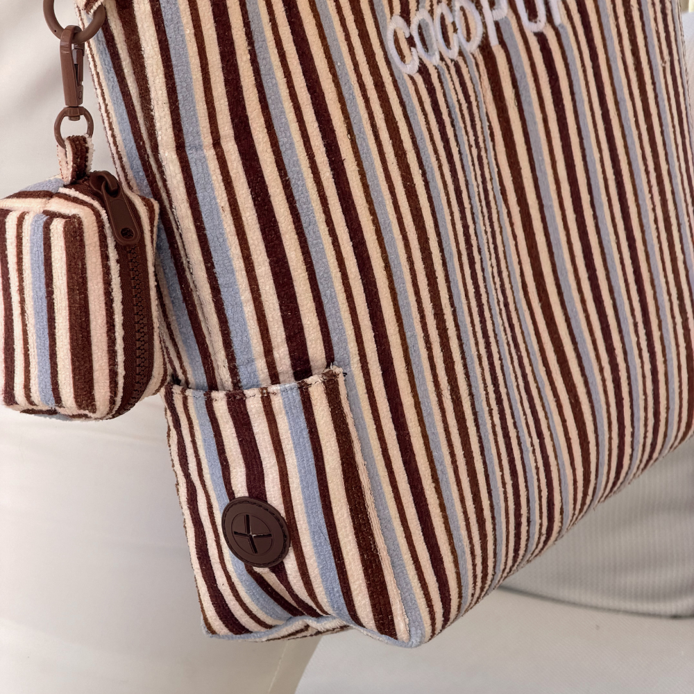 Brown and blue striped tote bag with small matching pouch and round button detail.