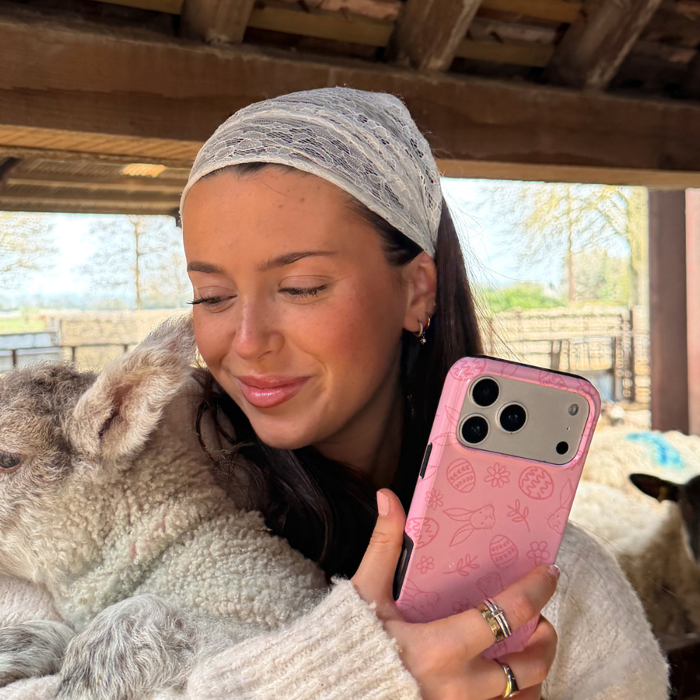 girl holding lamb and blushbunny tough phone case in hand