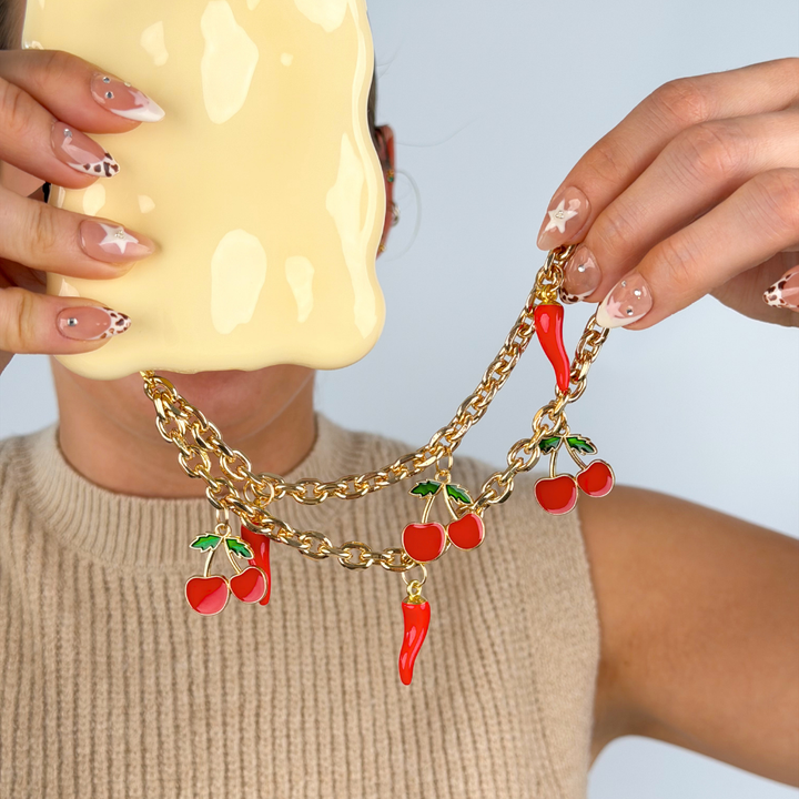 Girl holding cherry spice phone strap close up image in studio 