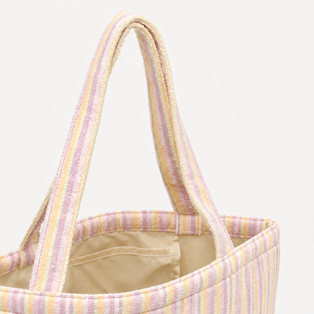 Pastel striped tote bag with two handles and a beige lining.