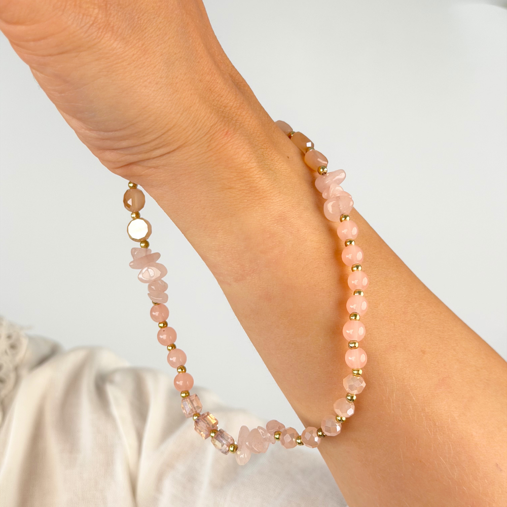 Girl with pink and gold phone strap on her wrist